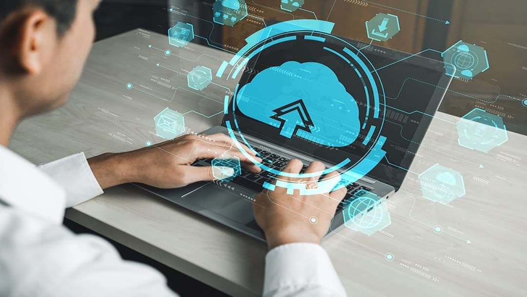 man working on a computer for cloud backup