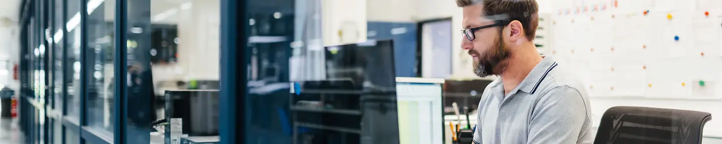 Man working at computer workstation.