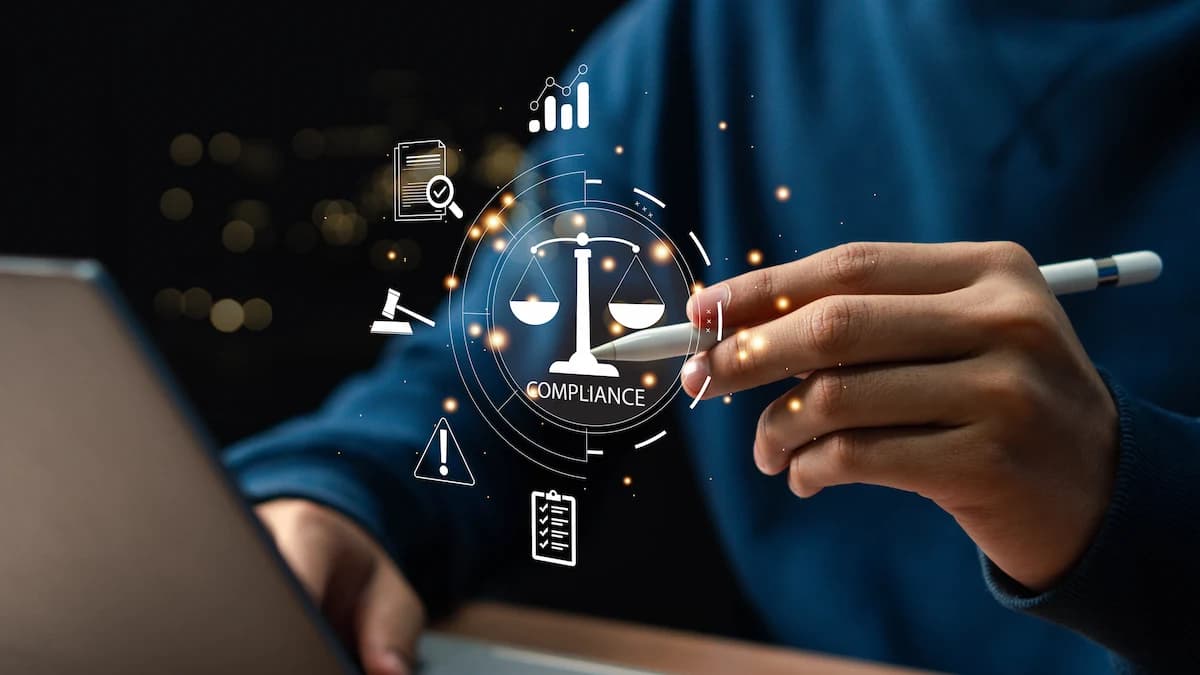 Photo illustration with hands typing on a laptop PC keyboard and selecting a scale titled "Compliance."