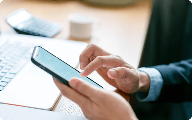 A close-up of someone using a cell phone.