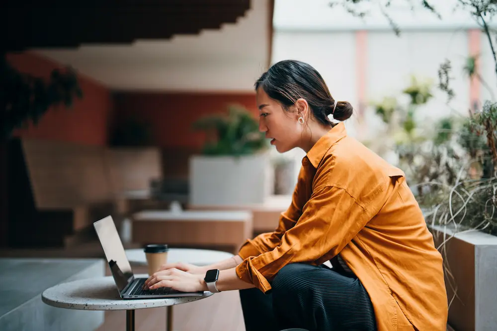Photo of woman working on laptop PC.